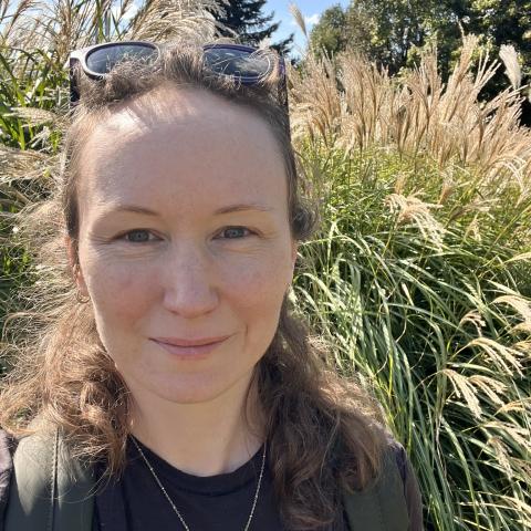 Portrait photo of Kiera in front of tall grasses