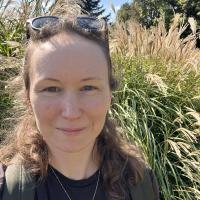 Portrait photo of Kiera in front of tall grasses